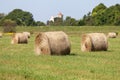 Field with some bundles of hay in the summer, harvest