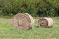 Field with some bundles of hay in the summer, harvest. Royalty Free Stock Photo