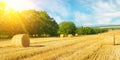 Field with straw bales after harvest on the sky background. Wide photo Royalty Free Stock Photo