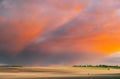 Field At Sunset Sunrise. Tractor Plowing Field In Spring Season Sunny Day. Bright Clouds On Background. Countryside Royalty Free Stock Photo