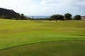 field to practice the sport of golf with the sea in the background Royalty Free Stock Photo