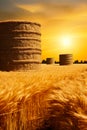Field of wheat with sunset in the background and stack of hay in the foreground. Generative AI Royalty Free Stock Photo