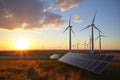 A field of wind turbines and solar panels at sunset Royalty Free Stock Photo