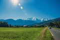 Fields with houses and road, forest, alpine landscape and blue sky in Saint-Gervais-Les-Bains Royalty Free Stock Photo