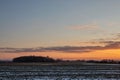 Cold Lithuanian winter. The fields are illuminated by the sunset.