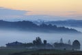 Fields and meadows under early morning fog in Podkarpacie region, Poland.