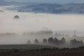 Fields and meadows under early morning fog in Podkarpacie region, Poland. Royalty Free Stock Photo