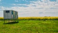 Fields with oilseed rape in bloom in Banat in Vojvodina.  Beehives in a field. Royalty Free Stock Photo