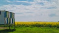Fields with oilseed rape in bloom in Banat in Vojvodina.  Beehives in a field. Royalty Free Stock Photo