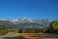 Fields, road, forest, alpine landscape and blue sky in Saint-Gervais-Les-Bains Royalty Free Stock Photo