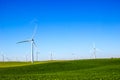 Fields With Three Bladed Energy Producing Windmills Royalty Free Stock Photo