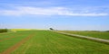 Fields and vineyard with road and wind turbines