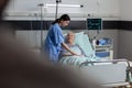 Fiendly doctor hands holding patient hand in hospital room Royalty Free Stock Photo