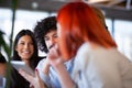 Fiends sitting at a cafe bar having a conversation looking at tablet. Positive face expressions Royalty Free Stock Photo