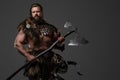 A fierce bearded Viking warrior in fur and light armor