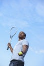 Fierce male African American tennis player is serving the ball Royalty Free Stock Photo