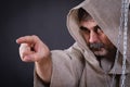 Fierce monk-man with beard is pointing somewhere Royalty Free Stock Photo