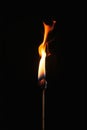 Fiery Anomalies: A Closeup Profile of a Lit Matchstick on a Bar