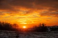 Fiery bright orange sunrise on a cold winter day. Early morning before hunting