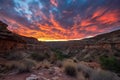 fiery canyon sunset, with clouds and blue sky in the background