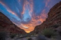 fiery canyon sunset, with clouds and blue sky in the background