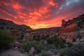 fiery canyon sunset with silhouetted rock formations and clouds