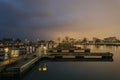 Fiery evening sky behind empty boat docks on chilly night