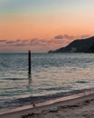 Fiery Farewell: Sun Dips Below Horizon in Dramatic Beach Sunset