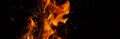 Fiery flame with sparks on a black background. Texture element for barbecue or cooking