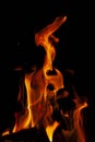 Fiery flame with sparks on a black background. Texture element for barbecue or cooking