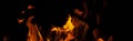 Fiery flame with sparks on a black background. Texture element for barbecue or cooking