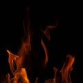 Fiery flame with sparks on a black background. Texture element for barbecue or cooking