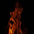 Fiery flame with sparks on a black background. Texture element for barbecue or cooking