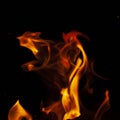 Fiery flame with sparks on a black background. Texture element for barbecue or cooking