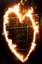 a fiery heart glows with a red flame at night. valentine`s day and love symbol Royalty Free Stock Photo