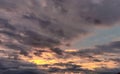 Fiery orange, pink stormy sky and alarming storm clouds at dawn