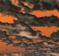 Fiery orange sky with dark black storm clouds background Royalty Free Stock Photo