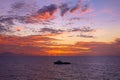 Fiery orange sunset sky warm light with clouds on the sea Beautiful for background with crew boat for oil and gas platform