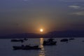 Rowing boats and speedboats in silhouettes. Royalty Free Stock Photo