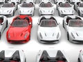 Fiery red sports car stands out from the crowd of white sports cars