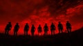 A fiery red sunset silhouettes silhouetted cowboys Royalty Free Stock Photo