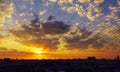 Fiery reddish sunrise over a sleeping city