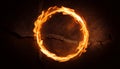 Fiery ring of flames on dark cracked background. Blurred motion. Abstract burning round shape Royalty Free Stock Photo