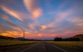 Fiery skies light up the highway at sunset Royalty Free Stock Photo