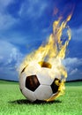 Fiery soccer ball on grass