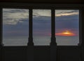 Fiery sunrise at the sea seen through the window of a villa. Adriatic sea. Italy