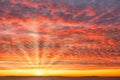 Fiery Sunrise Sky with Dramatic Mackerel Clouds, Sun and Sun Rays Royalty Free Stock Photo