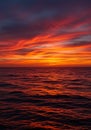 Fiery sunset over dark ocean waves with dramatic clouds water Royalty Free Stock Photo