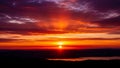 Fiery Sunset Over Distant Hills and Calm Lake with Dramatic Rays of Light and Clouds Royalty Free Stock Photo