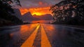 Fiery Sunset Reflections on a Wet Road Through Mountains Royalty Free Stock Photo